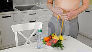 Fat man measuring his waist, healthy eating, healthy lifestyle concept, fitness diet