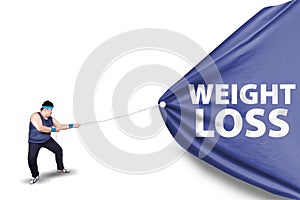 Fat man pulling a weight loss banner 2