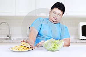 Fat man refuse junk food photo