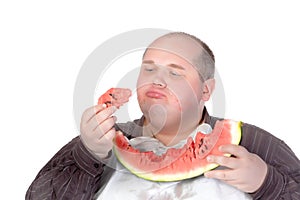 Fat man savouring a slice of watermelon