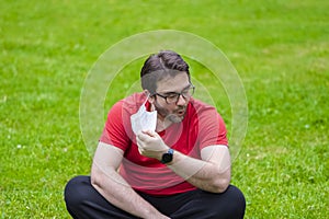 Fat man taking off face mask to inhale some fresh air