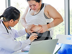 Fat overweight Asian woman got advise from expert medical doctor  in clinical