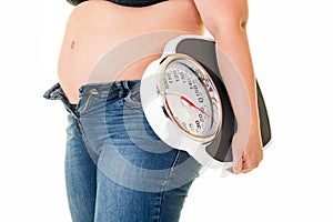 Fat overweight woman carrying a bathroom scale