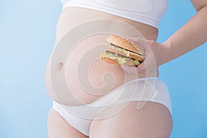 Fat overweight woman take hamburger