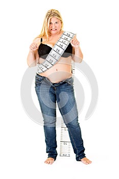 Fat overweight woman wearing a tape measure