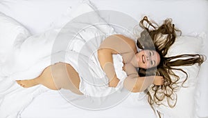 Fat plump woman with long hair, beaming with joy, view from above, copy space photo