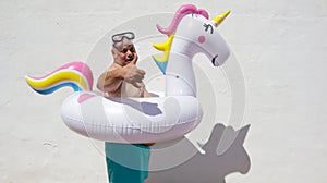 Fat ridiculous man with an unicorn float