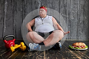 Fat serious man refuses junk unhealthy food