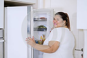 Fat woman caught red handed checking out fridge