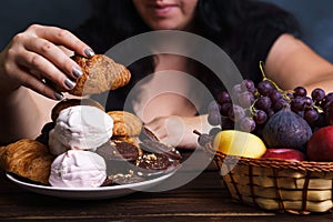 Fat woman choosing between junk food and fruits