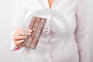 Fat woman eating chocolate