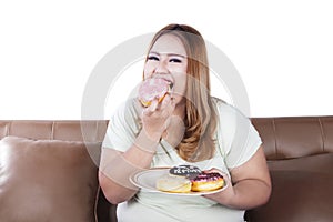 Fat woman eats donuts