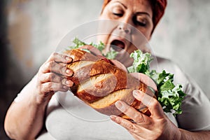 Fat woman eats sandwich, overweight and bulimic