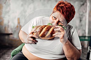 Fat woman eats sandwich, overweight and bulimic