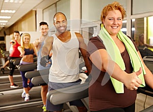 Fat woman enjoying training in gym