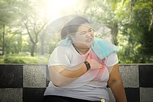 Fat woman having heart attack in the park