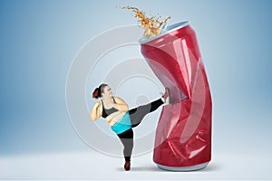 Fat woman kicking soft drink
