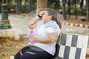 Fat woman looks exhausted after exercising