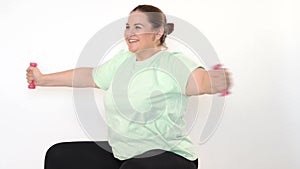 Fat woman making exercises with dumbbells