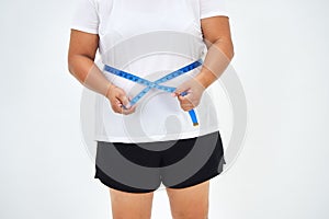 Fat woman measuring waist with tape