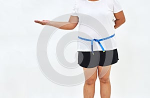 Fat woman measuring waist with tape