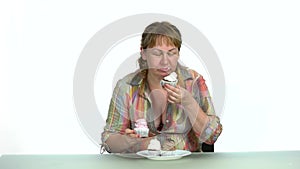 Fat woman sitting and eating sweet food.
