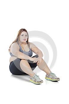 Fat woman sitting in studio after exercising