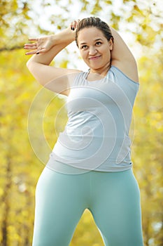 Fat woman and sports. Does exercise for weight loss in the fresh air.