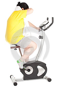 Fat woman on stationary fitness bicycle