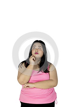 Fat woman thinking something on studio