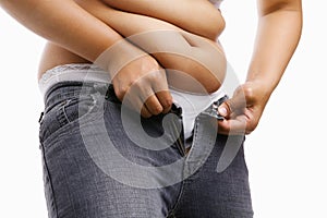 Fat woman trying to put on her tight jeans