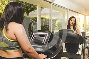 Fat Woman weight loss running on treadmill mirror reflect face smile happy to exercise in fitness gym