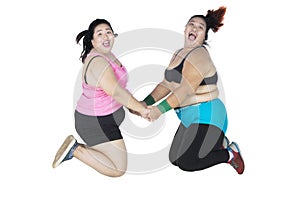 Fat women jumping together