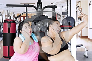 Fat women taking picture in the gym center