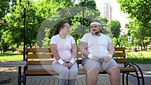 Fat young man and woman doing first step in acquaintance, getting closer, flirt