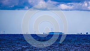 Fata Morgana (mirage) of coastline with wind turbines photo