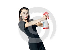 The fatal woman in a black dress with a spray for washing glasses pretending to be a secret agent, holding a spray like a gun.