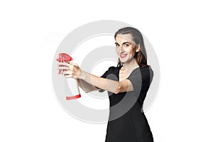 The fatal woman in a black dress with a spray for washing glasses pretending to be a secret agent, holding a spray like a gun.