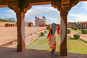 Fatehpur Sikri medieval architectural ruins with woman tourist at Agra India