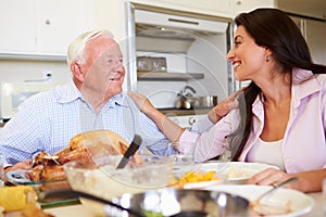 Father And Adult Daughter Having Family Meal At Table