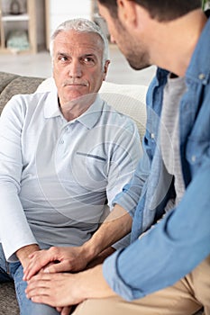 Father and adult son enjoying quiet evening together at home