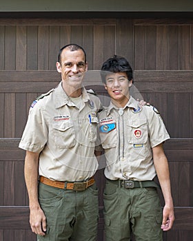 Father and Amerasian son enjoying the Boy Scouts of America in their uniforms.