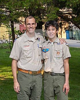 Father and Amerasian son enjoying the Boy Scouts of America in their uniforms.