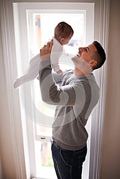 Father, baby in air and bonding, happy with love for growth and child development with joy at family home. Man, infant