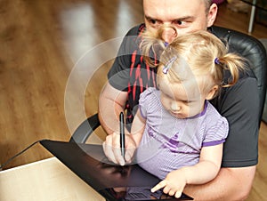 Father, baby and computer