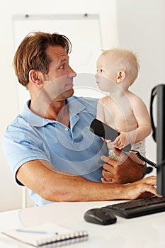 Father, baby and computer for remote work in home with desktop, communication and multitasking. Man, young male child