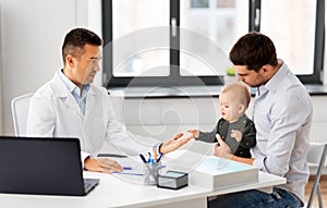 Father with baby and doctor at clinic