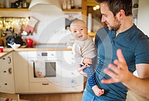 Father with a baby girl at home.