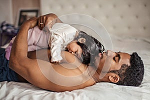 Father with a baby girl sleeping in the bedroom