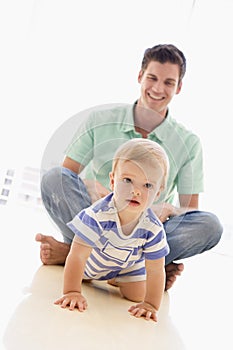 Father and baby indoors playing